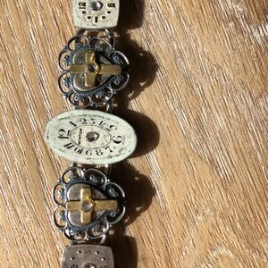 Artistic Silver and Gold Watch Face and Cross Bracelet